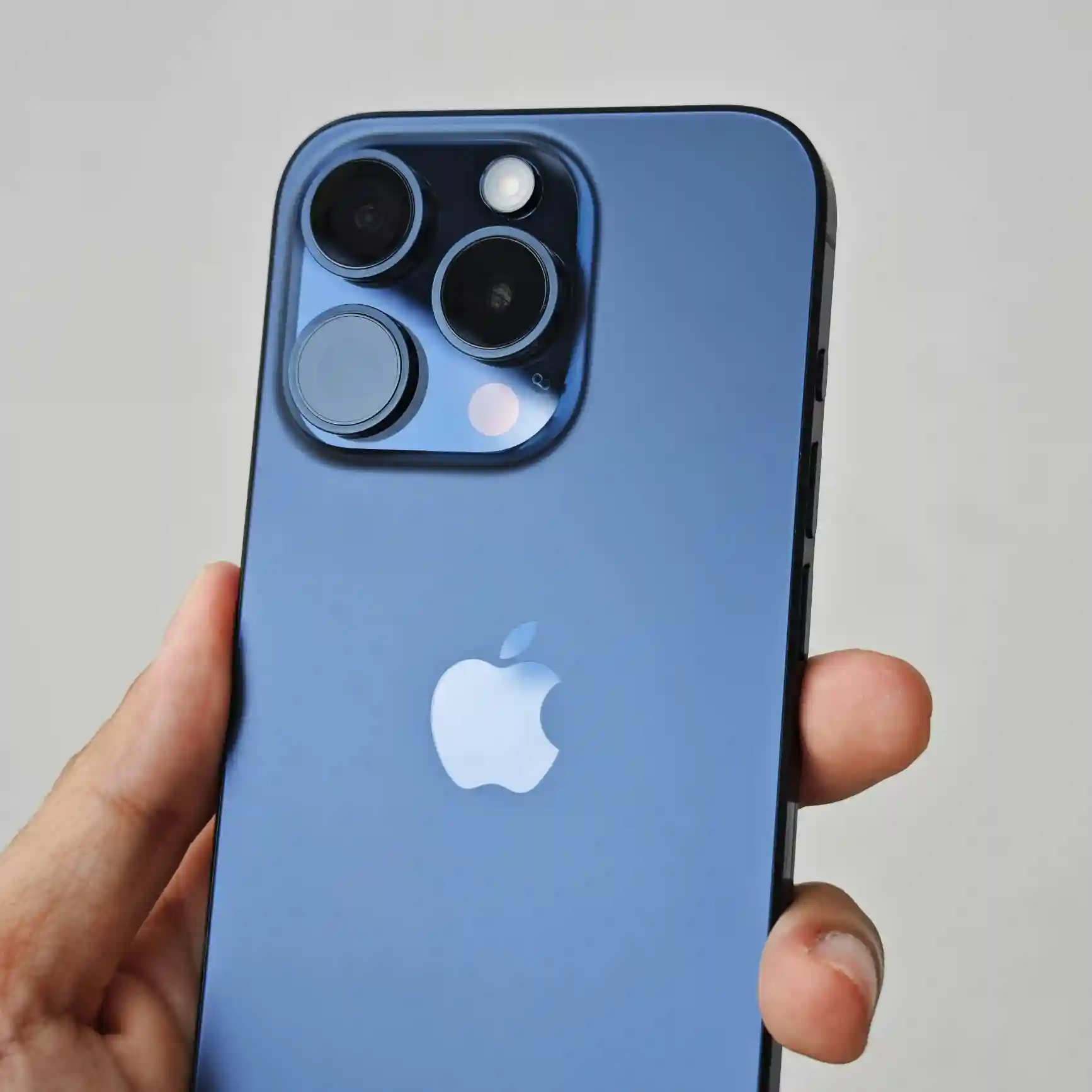 Blue Apple iPhone Pro held in hand